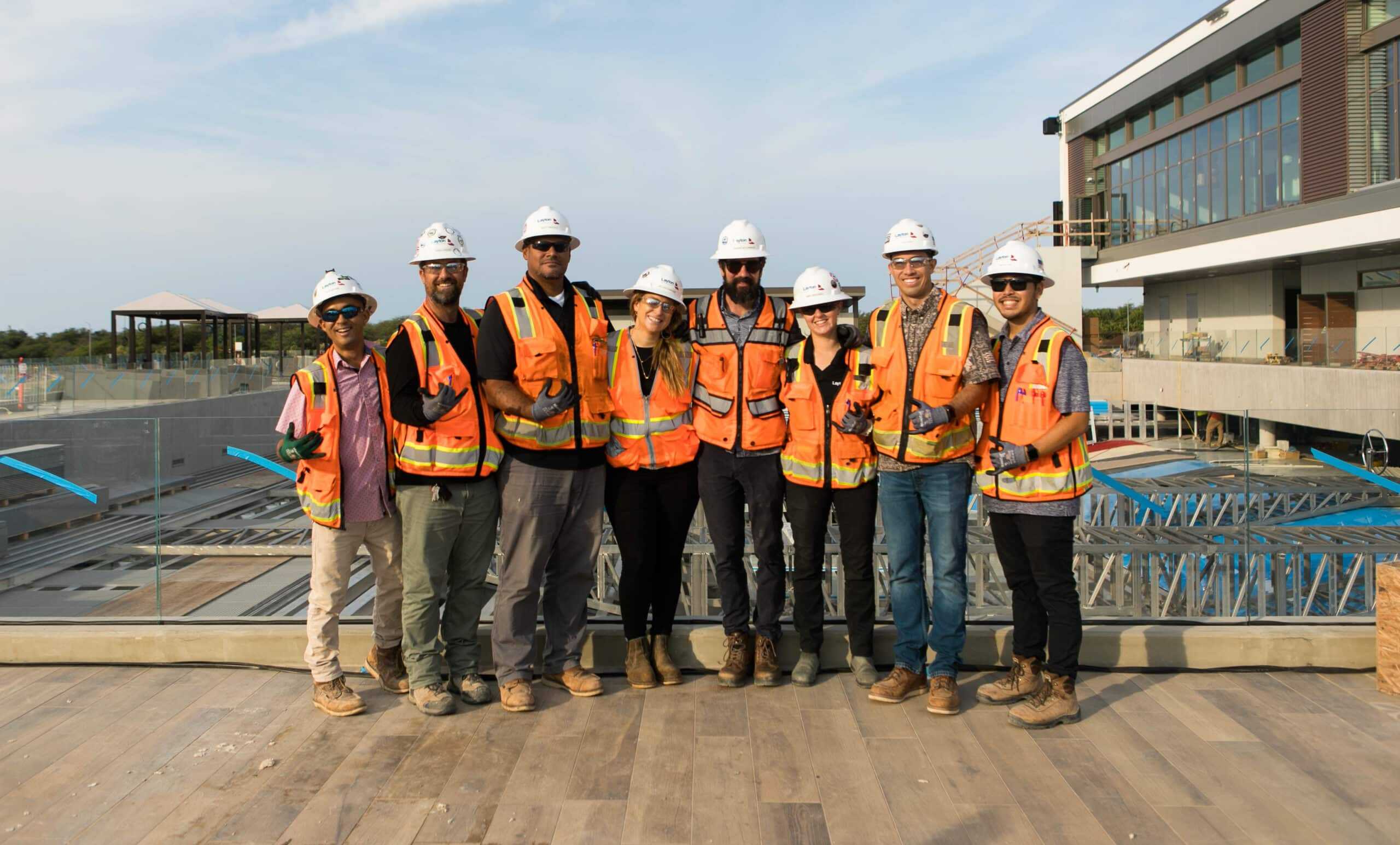 Construction team of diverse professionals wearing safety gear at a building site in Ipswich, showcasing expert IT support and digital infrastructure solutions for construction projects.
